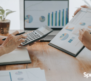 two people in a business meeting looking at charts and graphs to strategize for small business growth