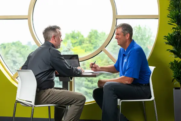 SpringGreen business consultant talking to client in office