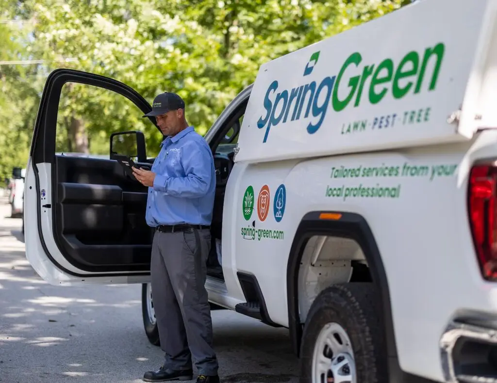 SpringGreen employee stepping out of SpringGreen truck