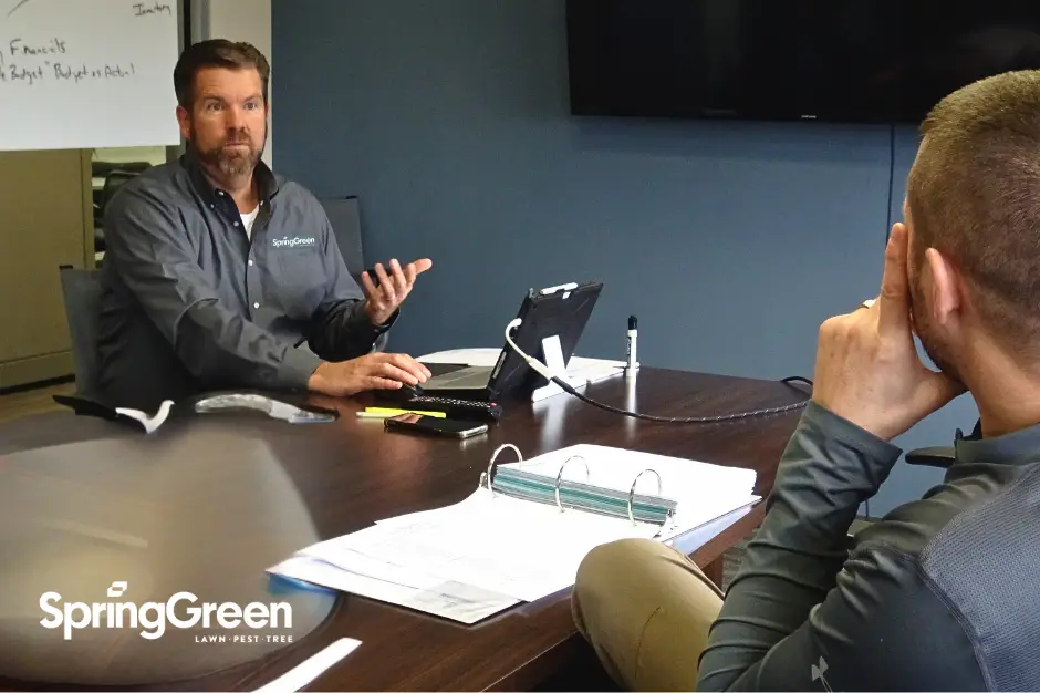 SpringGreen business consultant sitting with client in conference room