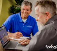 springgreen business consultant, consulting client sitting down and looking at laptop