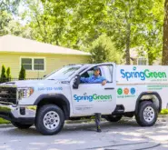 springgreen employee stepping out of springgreen truck looking at camera
