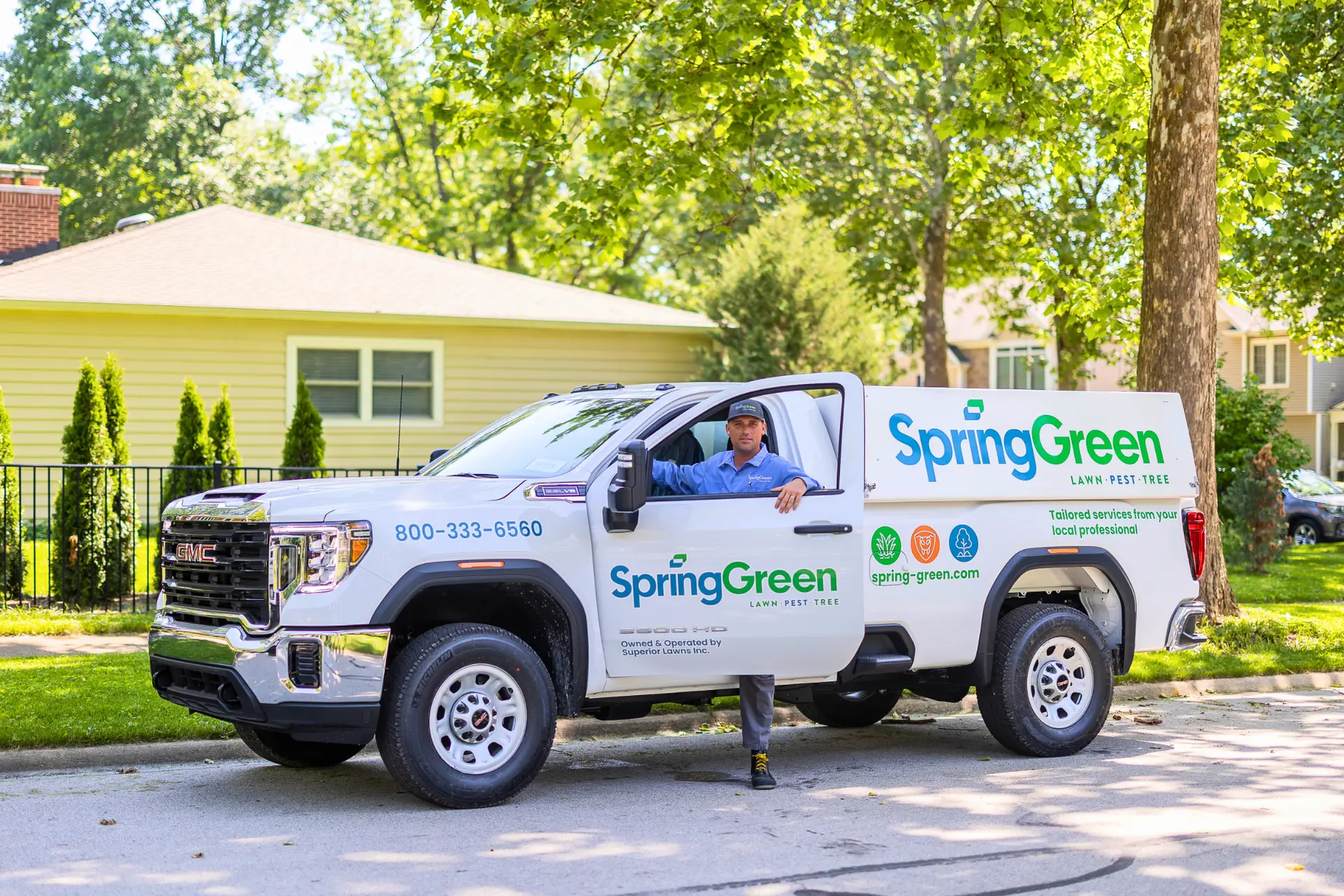 springgreen employee stepping out of springgreen truck looking at camera