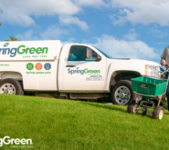 SpringGreen franchise owner delivering lawn care services behind SpringGreen truck