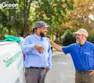 SpringGreen employees talking to eachother outside while working by SpringGreen truck