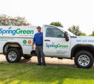 SpringGreen employee getting of SpringGreen truck