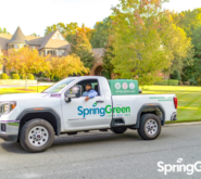 SpringGreen employee sitting in SpringGreen truck outside of clients house