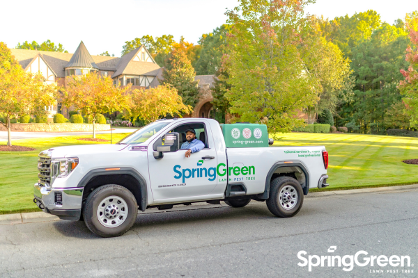 SpringGreen employee sitting in SpringGreen truck outside of clients house