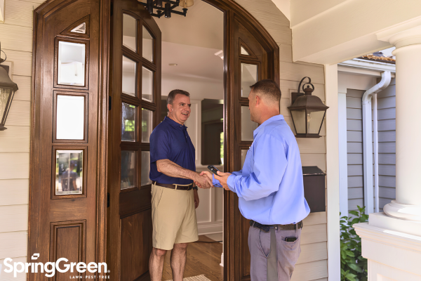 SpringGreen employee talking to homeowner at front door